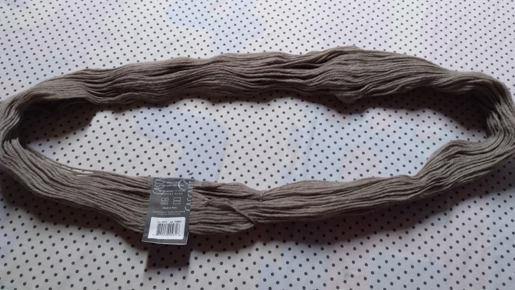 Hank of yarn laying open on the table ready for dyeing.